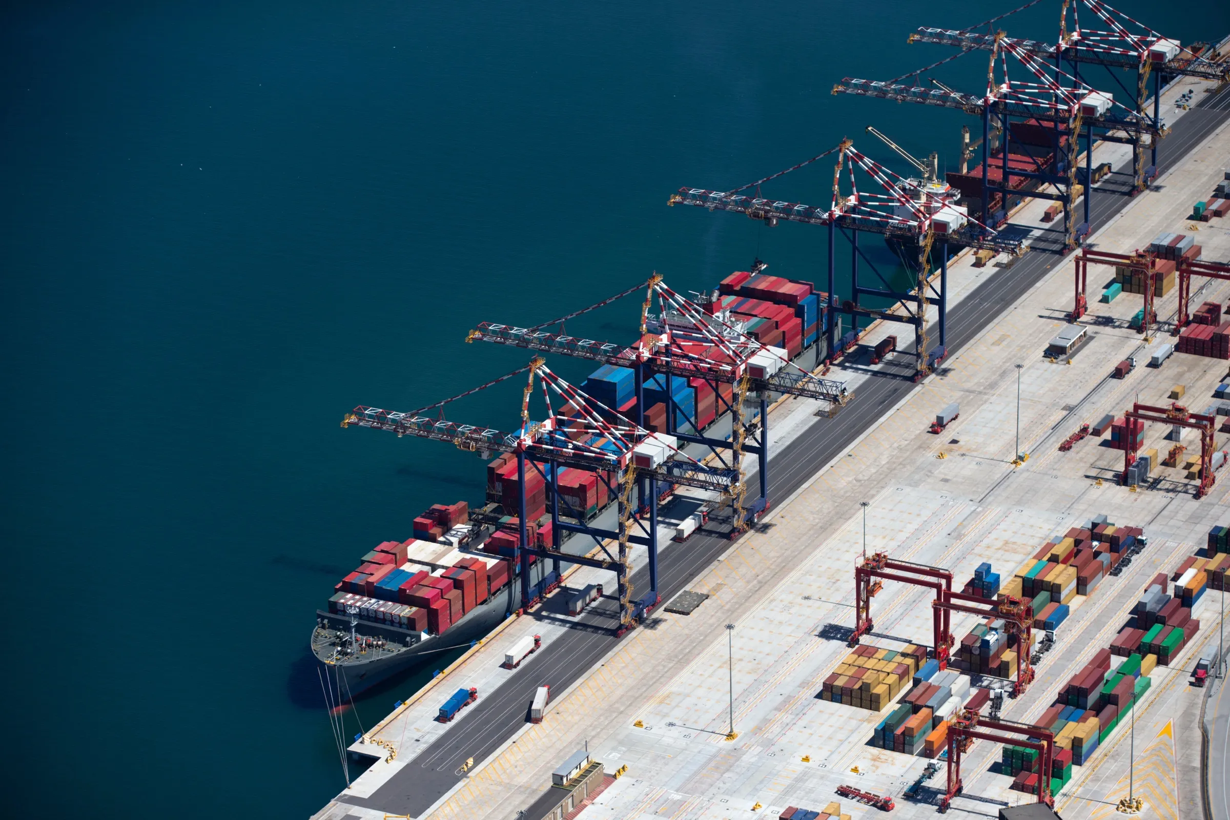 Container vessels alongside under gantry cranes, aerial view