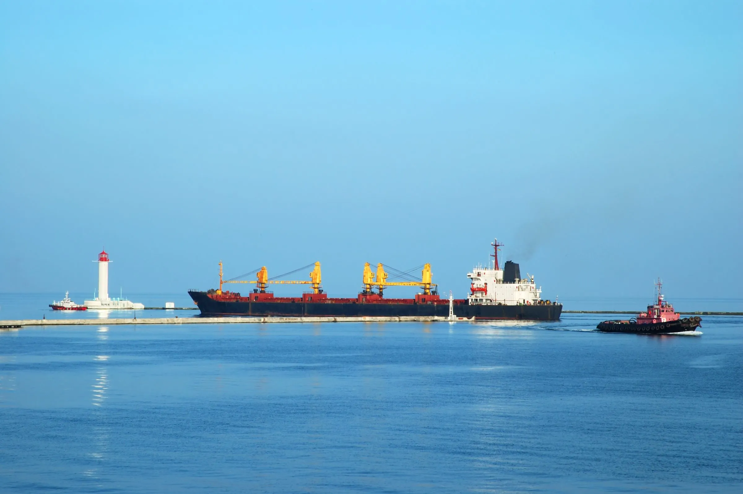 Vessel with tug on calm water off the coast